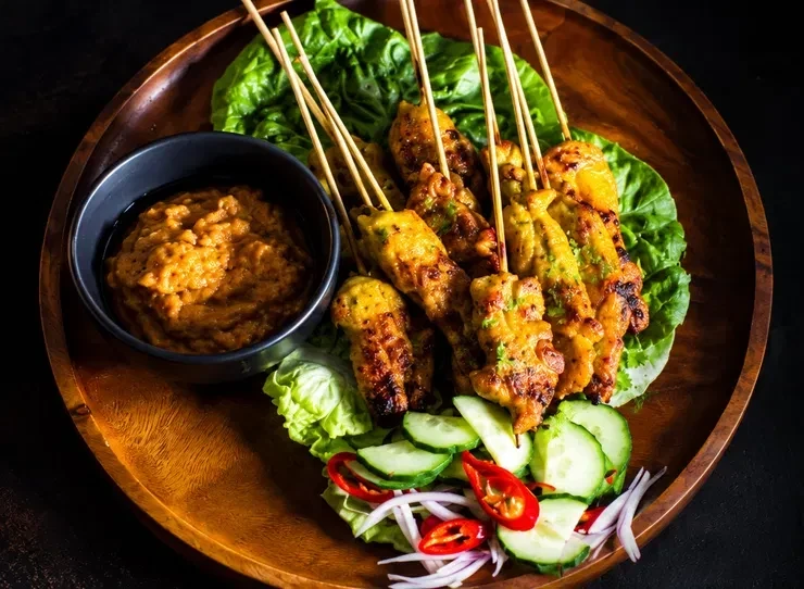 Chicken satay skewers with satay sauce, cucumber and chilli, made with Gourmet Thai Satay Marinade